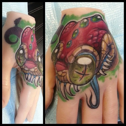 New school style colored hand tattoo of dead snake