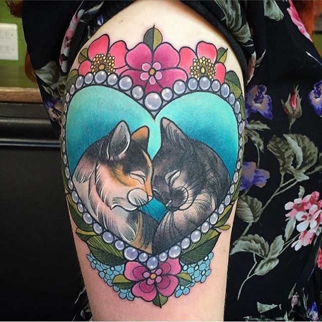 New school style colored heart shaped portrait tattoo on shoulder stylized with cat couple and flowers
