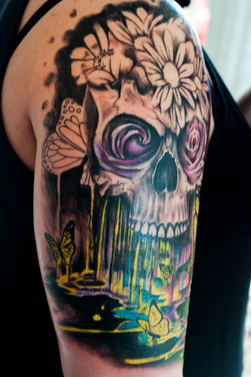 New school style colored human skull with flowers and butterflies tattoo on shoulder