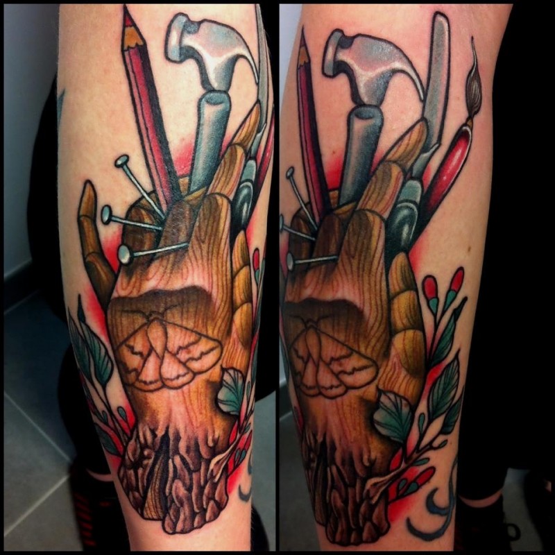 New school style colored leg tattoo of wooden hand with instruments