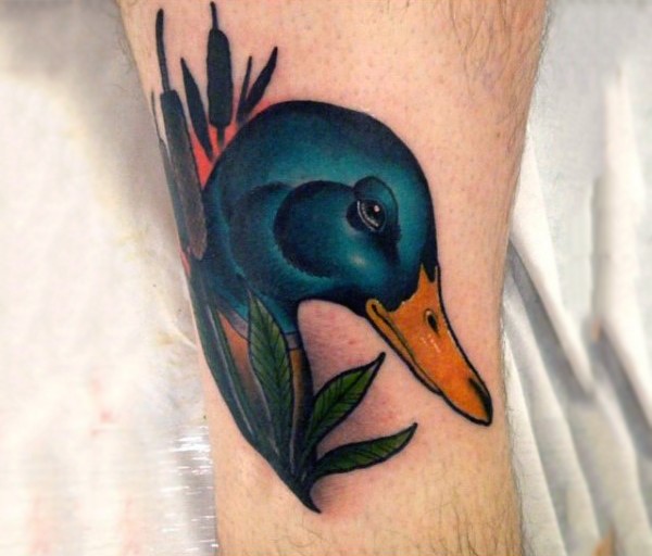 New school style colored leg tattoo of of duck in reed