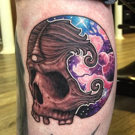 New school style colored leg tattoo of interesting looking skull stylized with space