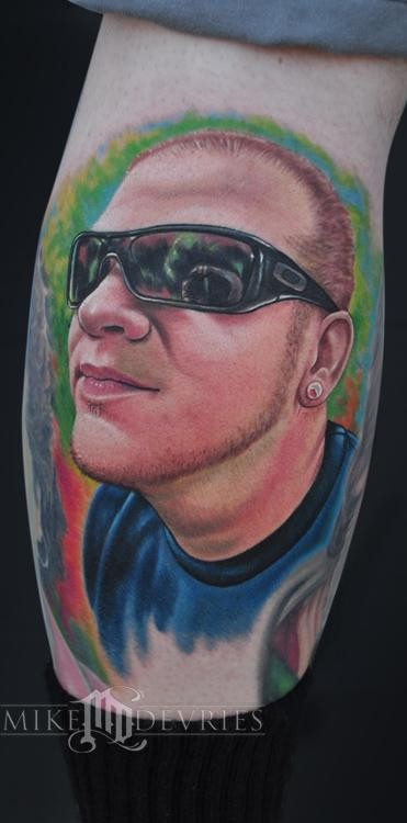 New school style colored leg tattoo of man in sun glasses portrait