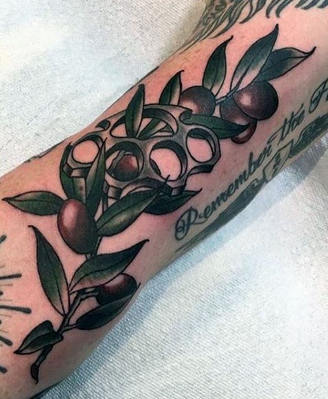 New school style colored leg tattoo of olive tree branch with brace knuckles