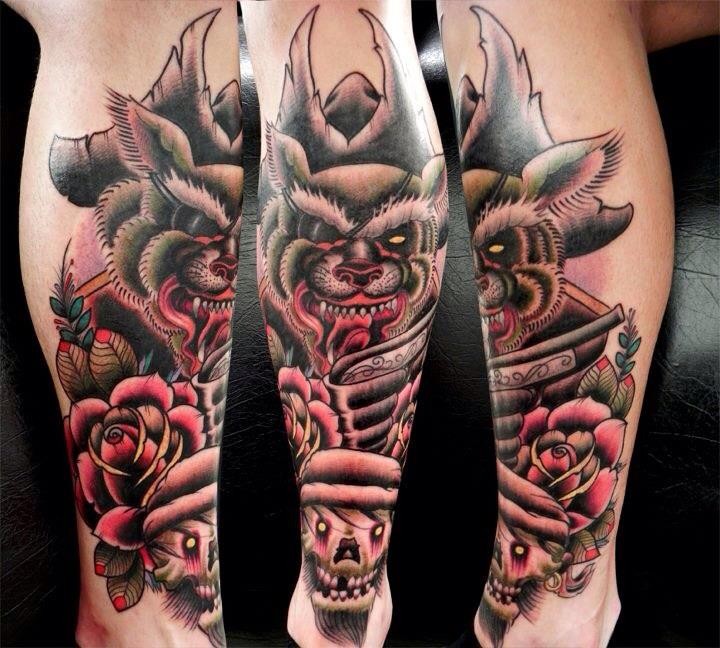 New school style colored leg tattoo of pirate wolf with skulls and roses
