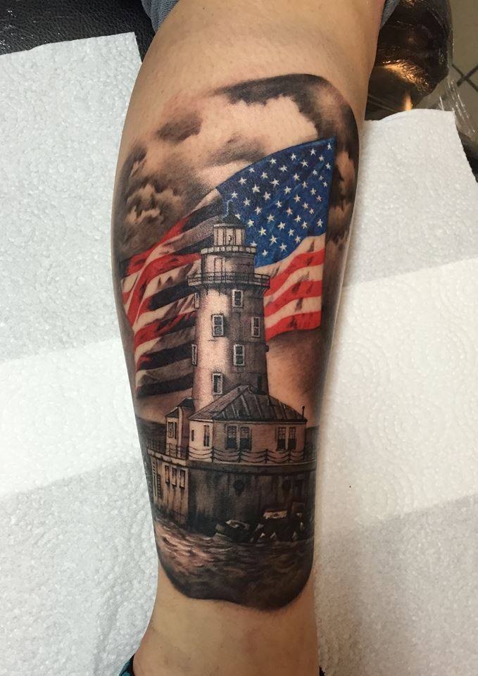 New school style colored leg tattoo of big lighthouse and flag