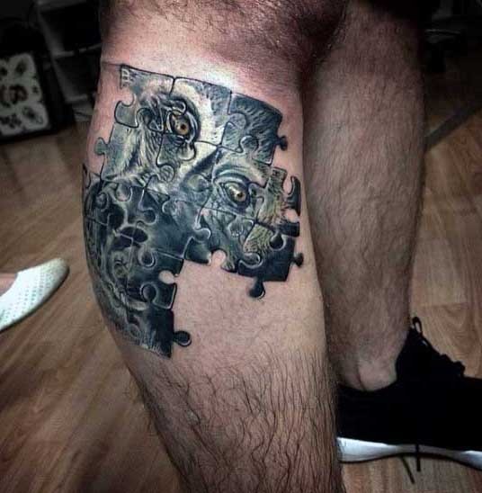 New school style colored puzzle pieces tattoo on leg stylized with monkey head