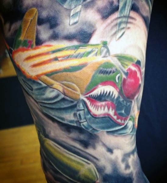 New school style colored shoulder tattoo of flying fighter plane