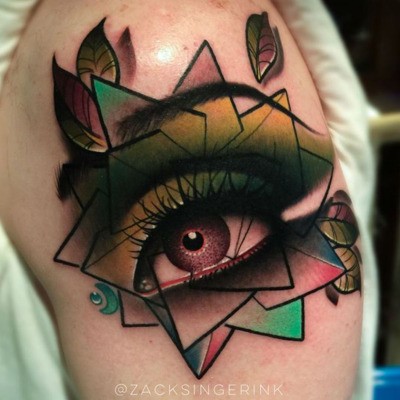 New school style colored shoulder tattoo of woman eye with figures