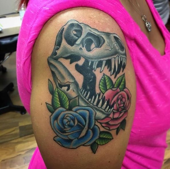 New school style colored shoulder tattoo of dinosaur skull and roses