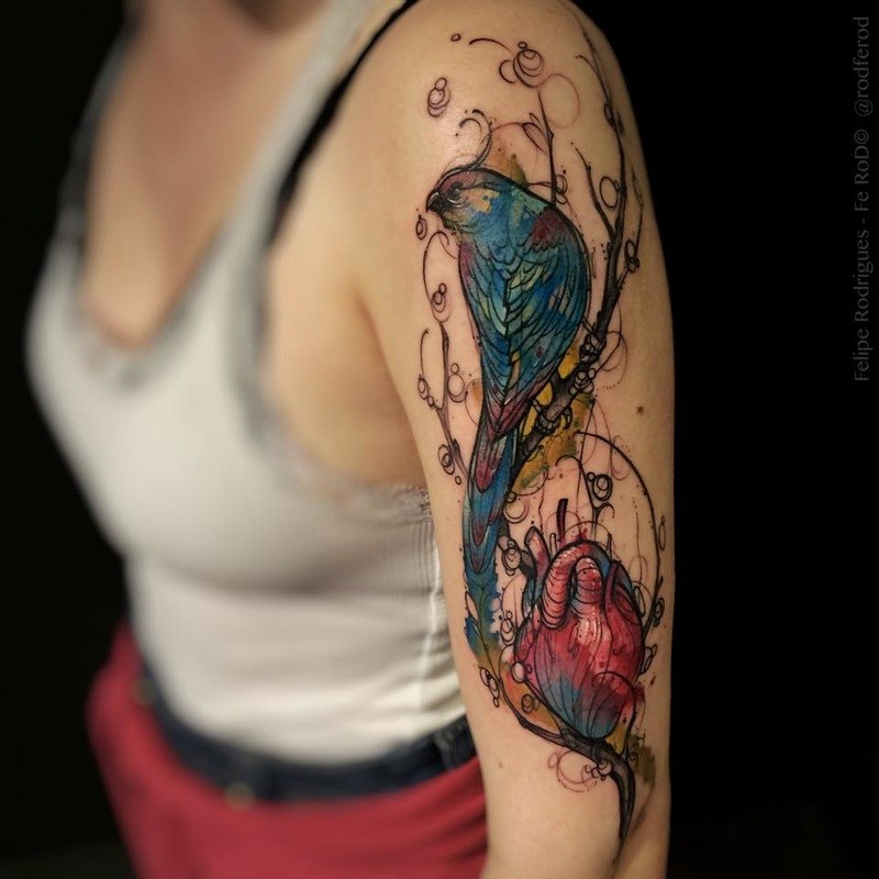 New school style colored shoulder tattoo of big bird with human heart