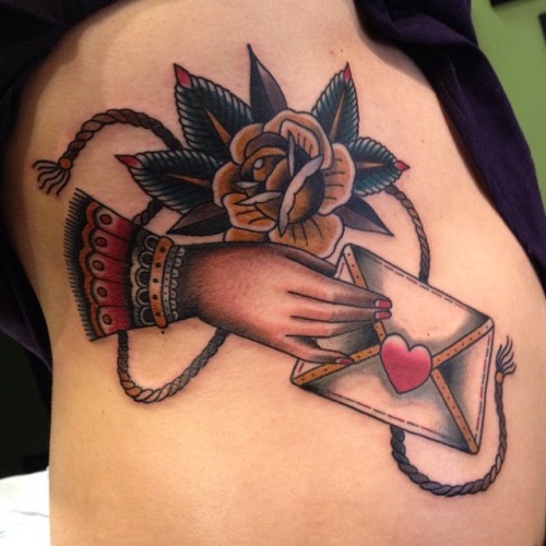 New school style colored side tattoo of woman hand with envelope and rose