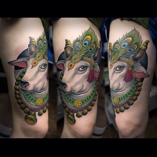 New school style colored thigh tattoo of big cow with feather