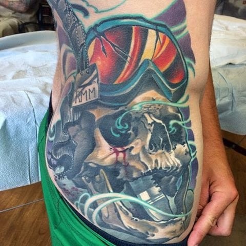 New school style colored thigh tattoo of snowboarders skull and knife