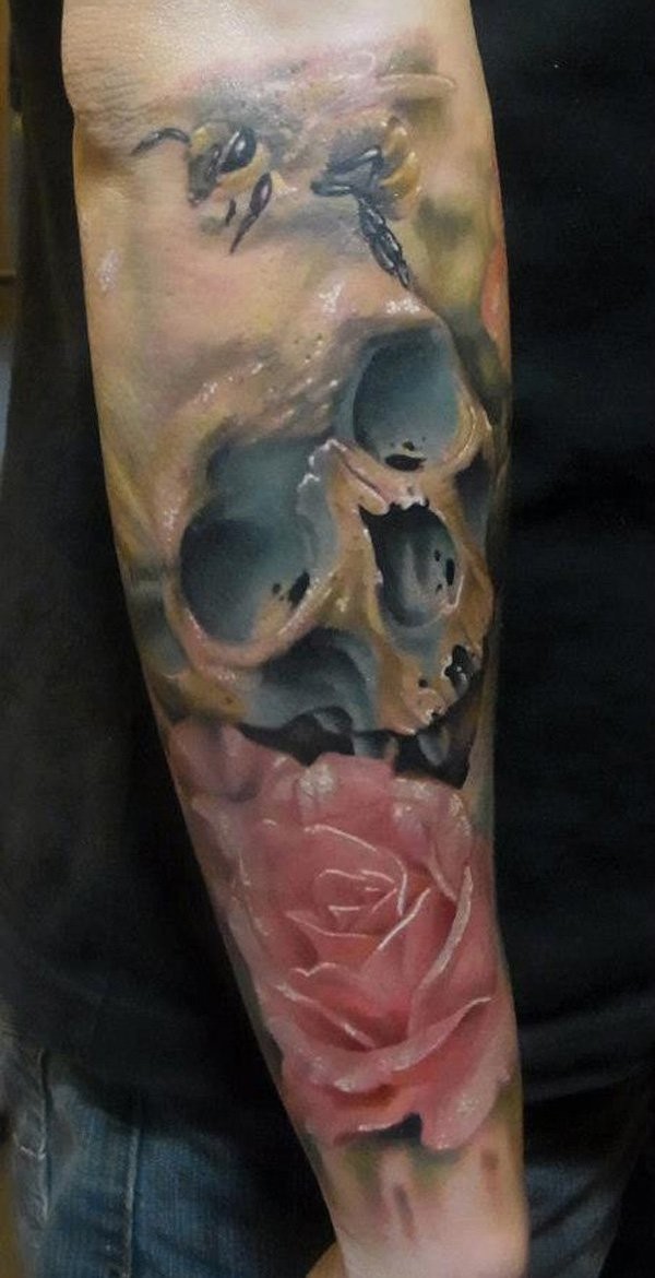 New school style colorful forearm tattoo of human skull with pink rose and small bee