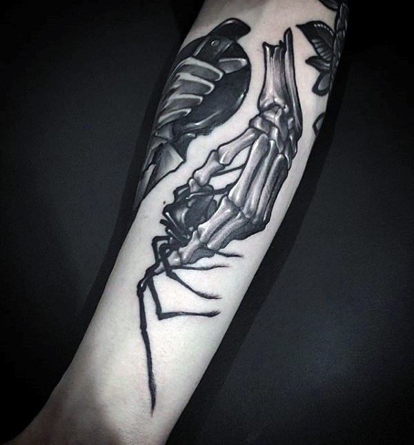 New school style detailed looking tattoo of skeleton hand holding spider