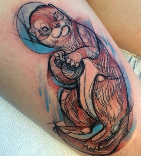 New style river otter with shell in paws tattoo on thigh for women