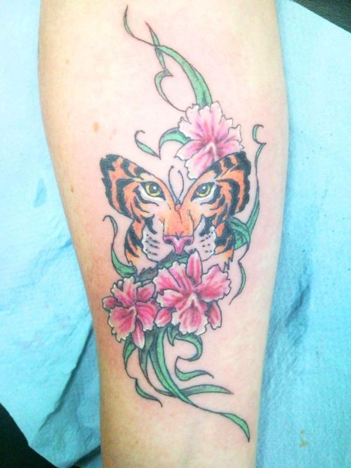 New tiger face butterfly colored tattoo on forearm with flowers