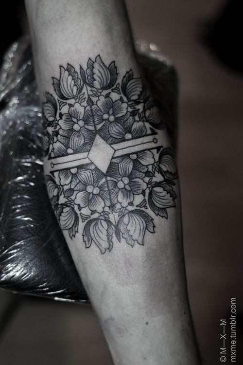 Nice and sweet designed black and white flowers with compass tattoo on arm