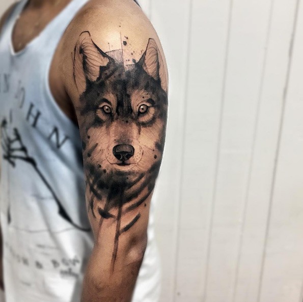 Nice cartoon style black ink upper arm tattoo of wolf head