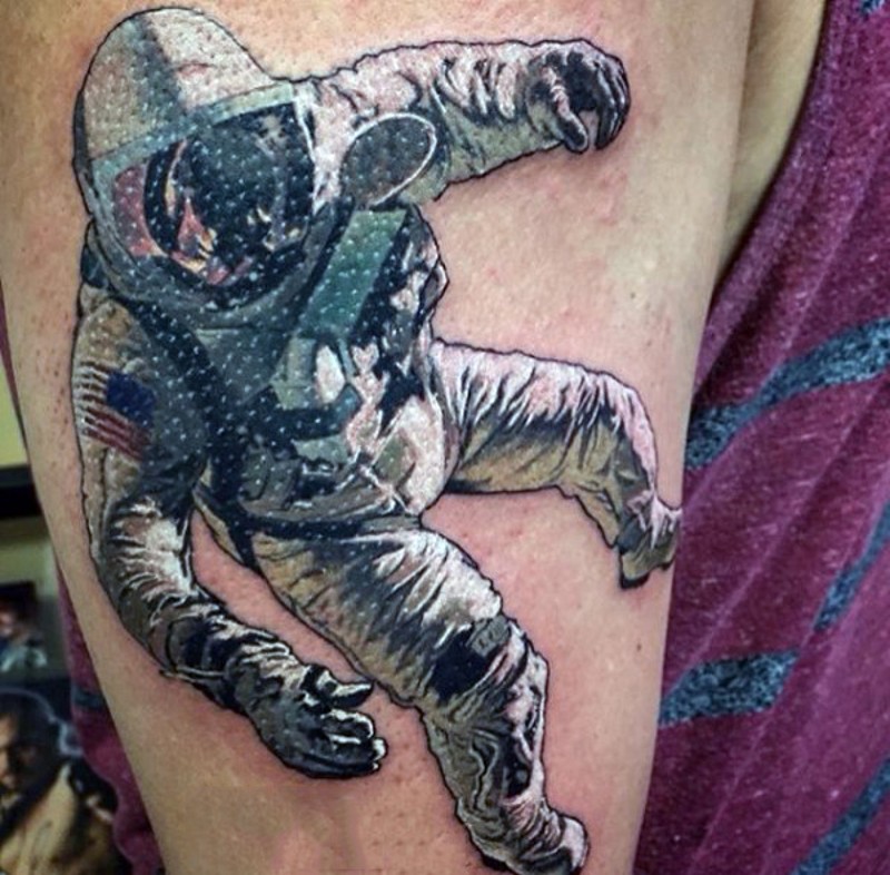 Nice colored and painted big realistic astronaut tattoo on upper arm