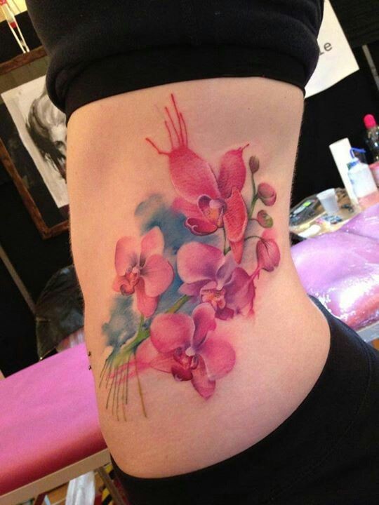 Nice colorful flowers tattoo on ribs