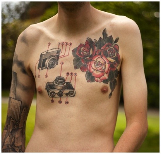 Nice combined old photo camera with flowers tattoo on chest