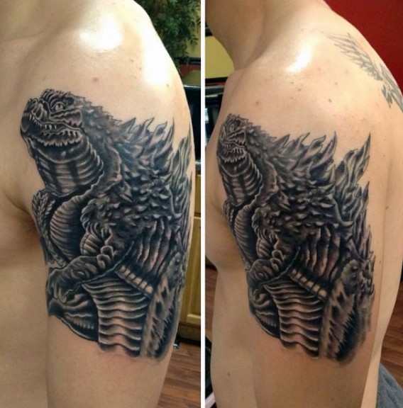 Nice detailed black and white evil Godzilla tattoo on shoulder