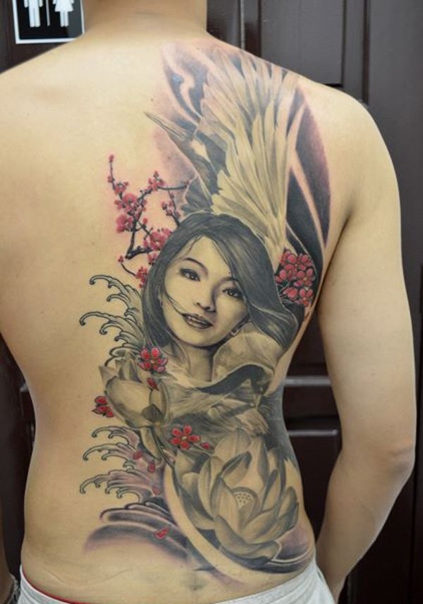 Nice girl and lotus flower tattoo on back