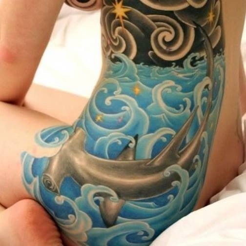 Nice hammerhead shark in sea tattoo on one side of body