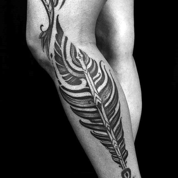 Nice looking black and white antic feather tattoo on leg