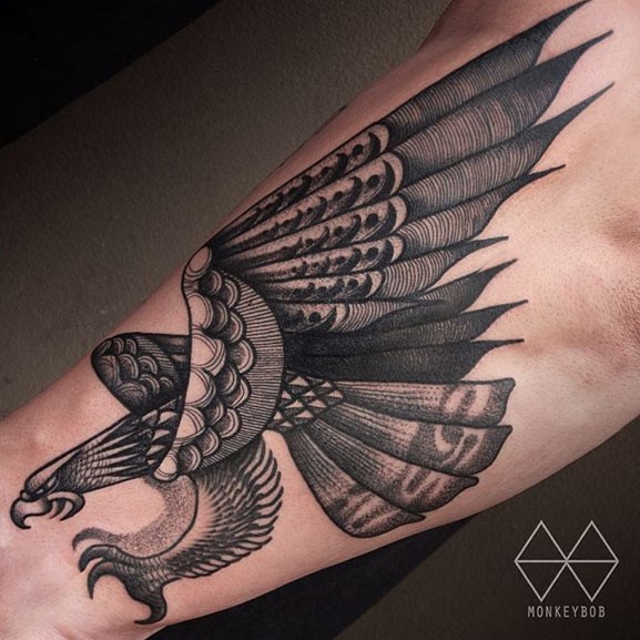 Nice looking black ink arm tattoo of big flying eagle