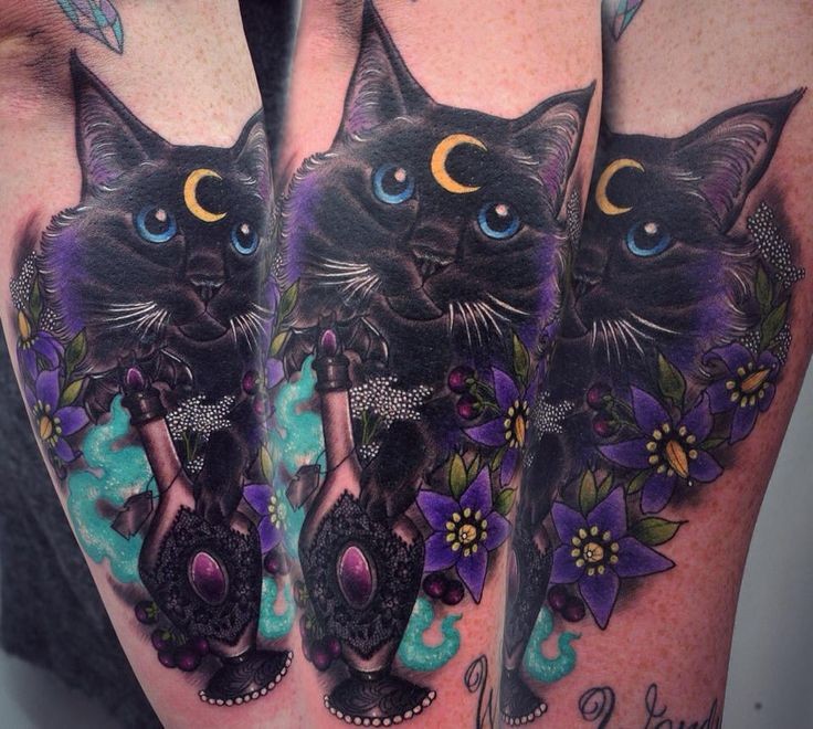 Nice looking colored arm tattoo of cat with flowers and moon