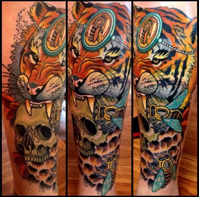 Nice looking colored arm tattoo of saint tiger and skull