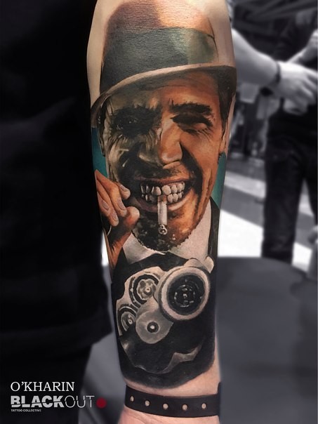 Nice looking colored arm tattoo of smoking mafioso with pistol
