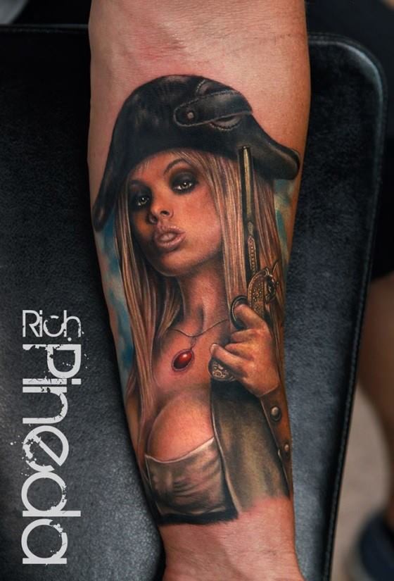 Nice looking colored forearm tattoo of sexy woman pirate with pistol