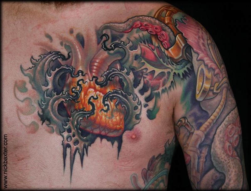 Nice looking colored human hear tattoo on chest