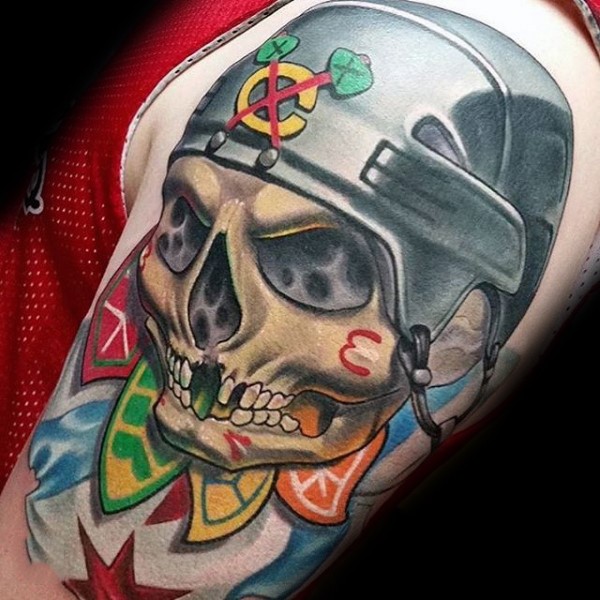 Nice looking colored shoulder tattoo of human skull with helmet and feather
