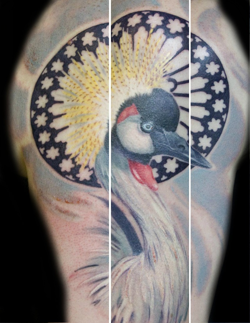 Nice looking colored shoulder tattoo of big flower with black circle