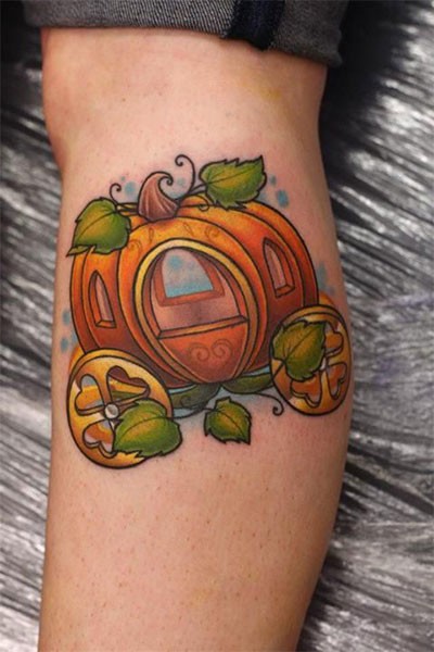 Nice looking colorful fantasy pumpkin coach tattoo on leg muscle