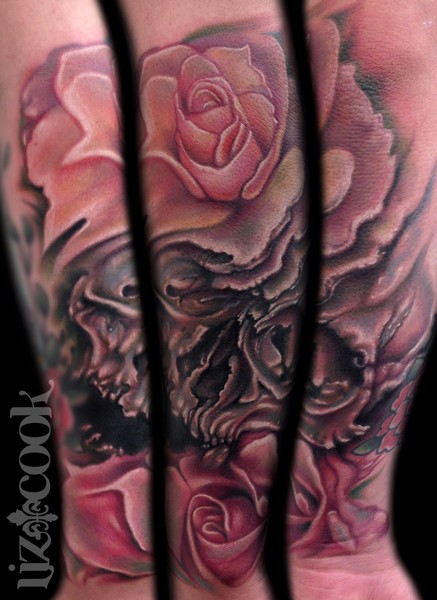 Nice looking illustrative style forearm tattoo of human skull with roses