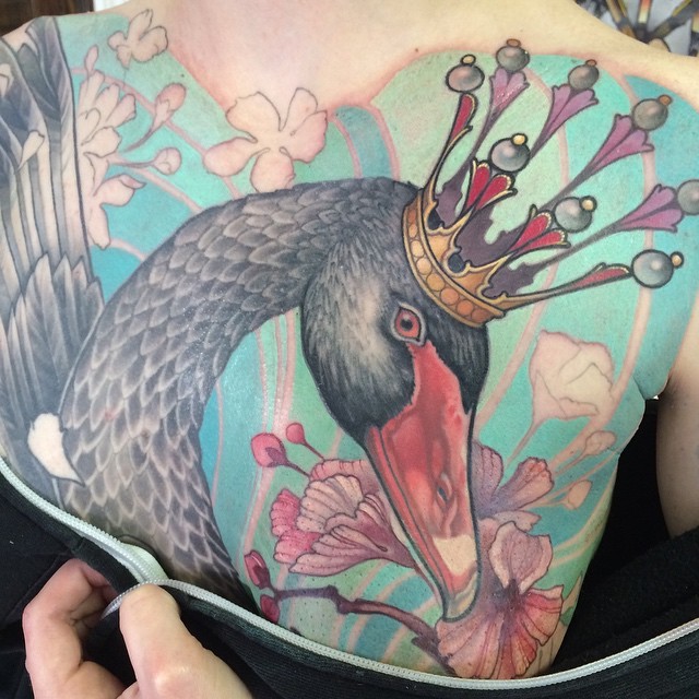 Nice looking multicolored swan king tattoo on whole back stylized with beautiful flowers