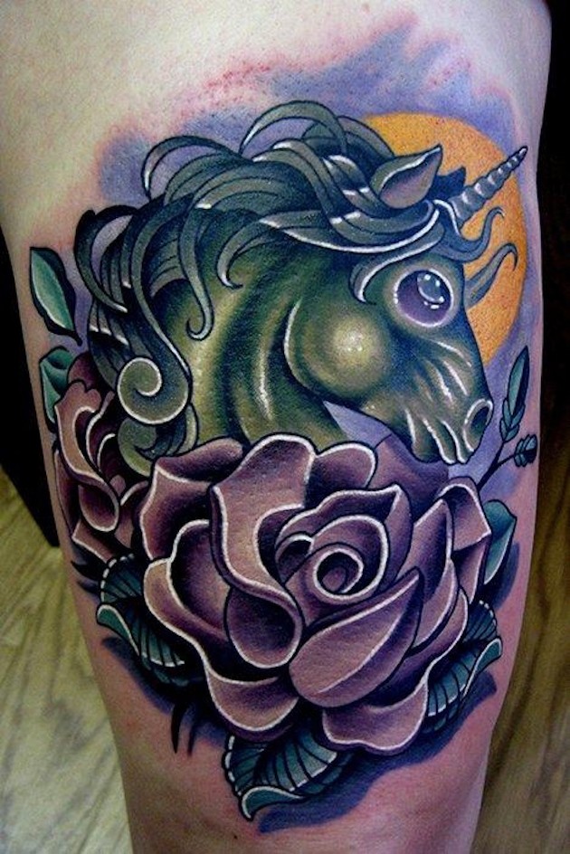 Nice looking multicolored thigh tattoo of fantasy unicorn with rose