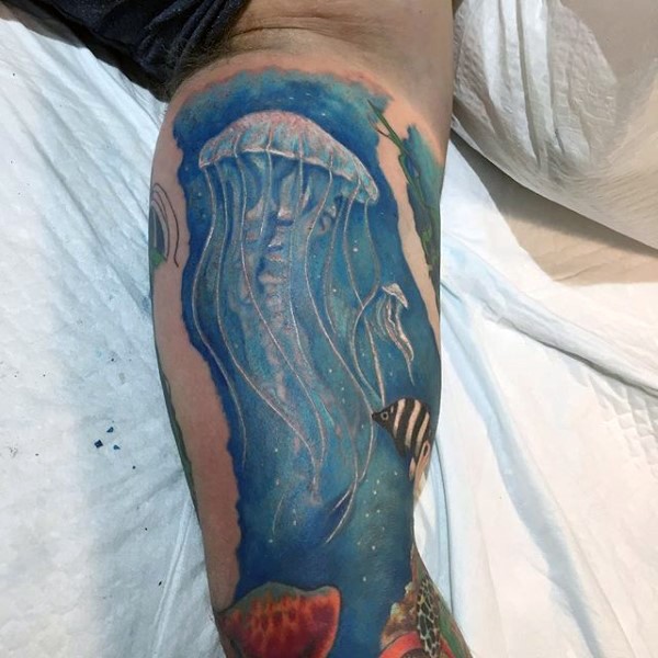 Nice painted big colorful underwater life with jellyfish tattoo on leg