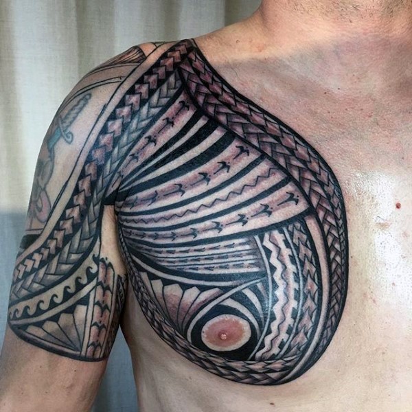 Nice painted colored Polynesian tattoo on chest and shoulder