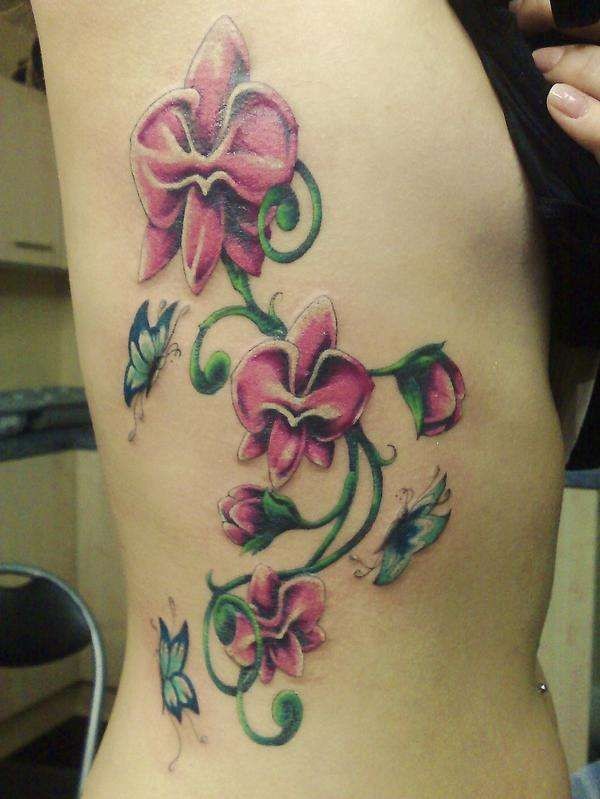 Nice pink orchids with butterflies tattoo on ribs
