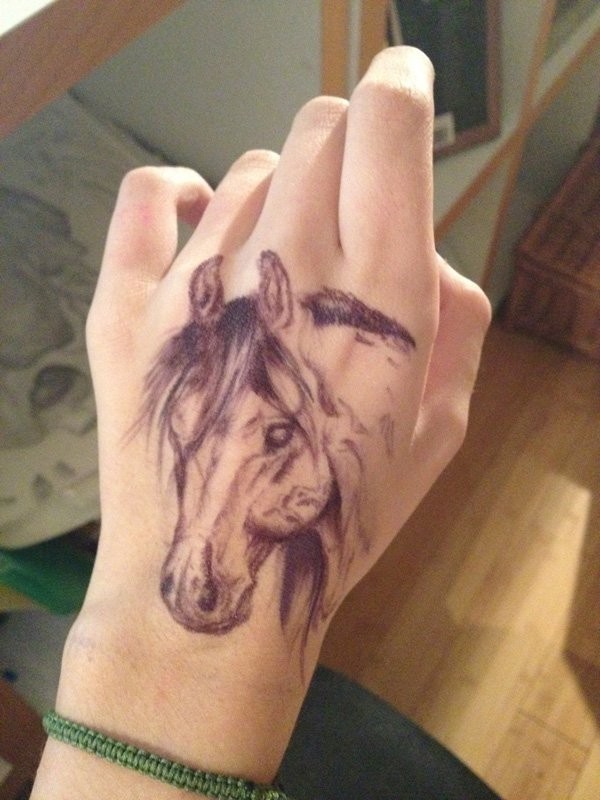 Nice realistic detailed horse head hand tattoo in homemade style