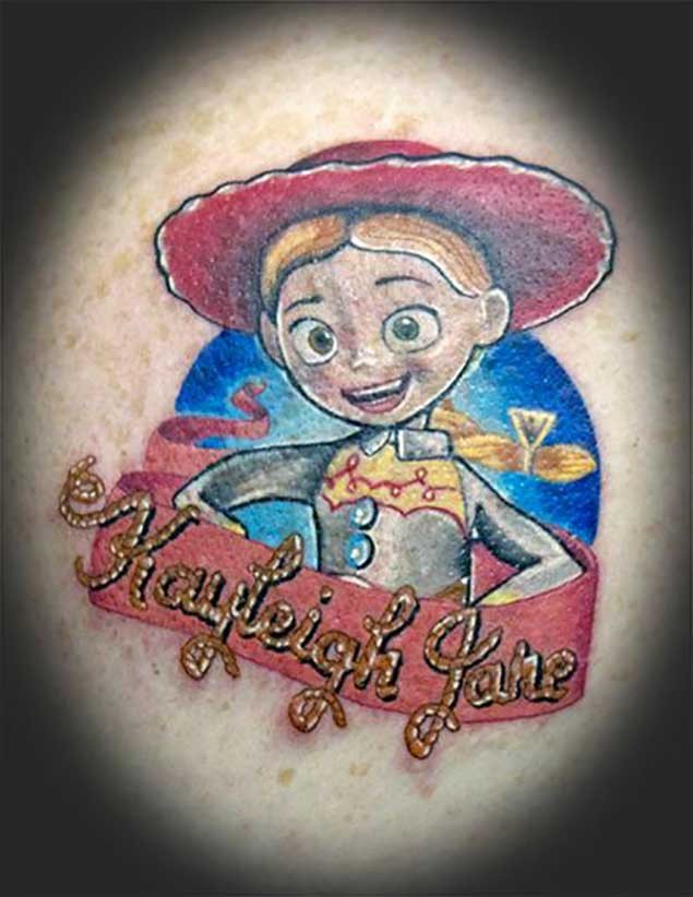 Old cartoon like colored funny woman cowboy tattoo with lettering