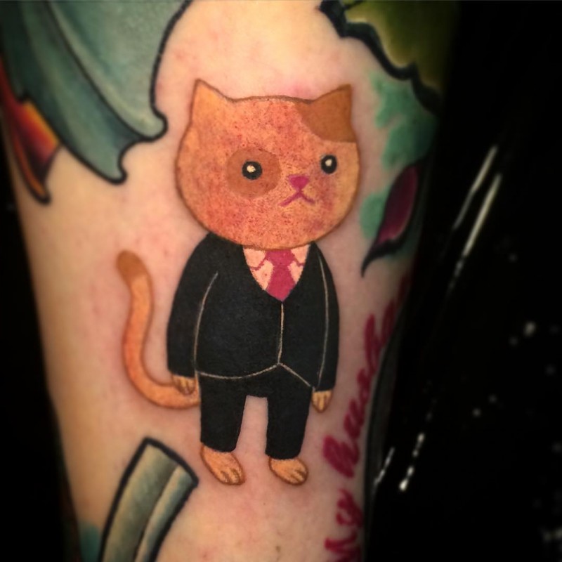 Old cartoon style colored cat in suit tattoo