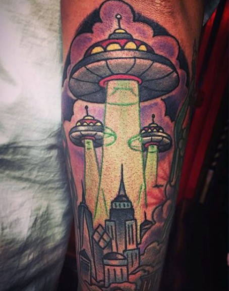 Old cartoons like colored alien ships tattoo on arm